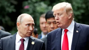 FILE PHOTO: U.S. President Donald Trump and Russia's President Vladimir Putin talk during the family photo session at the APEC Summit in Danang, Vietnam November 11, 2017. REUTERS/Jorge Silva/File Photo/Jorge Silva