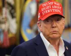 U.S. President Donald Trump wears a 'Trump Was Right About Everything!' hat, as he makes an announcement on the 2026 FIFA World Cup, in the Oval Office at the White House in Washington, D.C., U.S., August 22, 2025. REUTERS/Jonathan Ernst/Jonathan Ernst