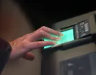 A man scans his fingerprints during a demonstration of the European Union's Entry/Exit System (EES) at the Eurotunnel terminal in Folkestone, Britain, September 23, 2025. REUTERS/Jack Taylor/Jack Taylor