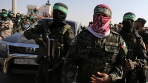 FILE PHOTO: Abu Ubaida, the spokesman of the Izz el-Deen al-Qassam Brigades, walks during an anti-Israel military show by Hamas militants in the southern Gaza Strip November 11, 2019. REUTERS/Ibraheem Abu Mustafa/File Photo/Ibraheem Abu Mustafa