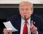 U.S. President Donald Trump holds a note that was handed to him by U.S. Secretary of State Marco Rubio during a roundtable on antifa, an anti-fascist movement Trump designated a domestic "terrorist organization" via executive order on September 22, at the White House in Washington, D.C., U.S., October 8, 2025. REUTERS/Evelyn Hockstein/Evelyn Hockstein