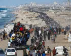 Palestinians, who were displaced to the southern part of Gaza at Israel's order during the war, make their way along a road as they return to the north after a ceasefire between Israel and Hamas in Gaza went into effect, in the central Gaza Strip, October 10, 2025. REUTERS/Mahmoud Issa/Mahmoud Issa