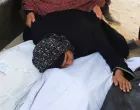 A relative embraces body bags, during the funeral for members of the Abu Amsha family, who were killed in an Israeli strike on a house on Saturday amid their military operation, according to medics, at Al-Shifa Hospital in Gaza City, September 21, 2025. REUTERS/Ebrahim Hajjaj/Ebrahim Hajjaj