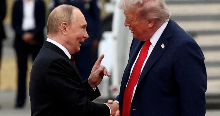 FILE PHOTO: U.S. President Donald Trump shakes hand with Russian President Vladimir Putin, as they meet to negotiate for an end to the war in Ukraine, at Joint Base Elmendorf-Richardson in Anchorage, Alaska, U.S., August 15, 2025. REUTERS/Kevin Lamarque/File Photo/Kevin Lamarque