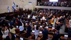 JERUSALEM - OCTOBER 13: U.S. President Donald Trump receives standing ovations as he addresses the Knesset, Israel's parliament, next to Amir Ohana, Speaker of the Israeli Knesset, and Israeli President Isaac Herzog on October 13, 2025 in Jerusalem.  Chip Somodevilla/Pool via REUTERS/Chip Somodevilla