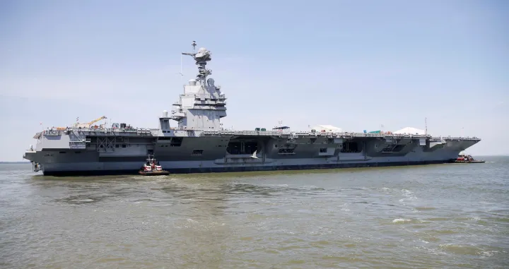 FILE PHOTO: Pre-Commissioning Unit Gerald R. Ford (CVN 78) is maneuvered by tug boats in the James River during the aircraft carrier's turn ship evolution in Newport News, Virginia, U.S. June 11, 2016. To match Special Report USA-TRUMP/CARRIERS  U.S. Navy/Mass Communication Specialist Seaman Apprentice Gitte Schirrmacher/Handout via REUTERS ATTENTION EDITORS - THIS PHOTO WAS PROVIDED BY A THIRD PARTY. EDITORIAL USE ONLY/File Photo/Handout.