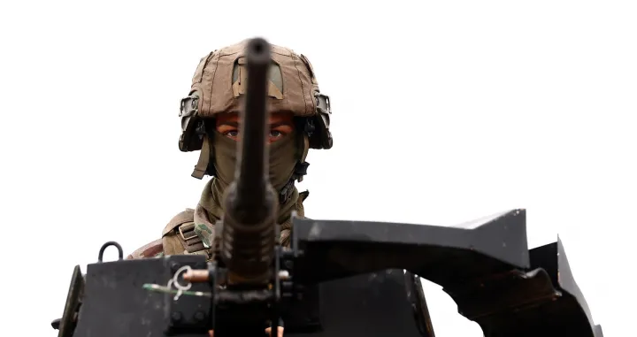 A soldier is perched atop an Armored Forward Vehicle (VAB) during a demonstration as part of a 'day dedicated to artillery' organized by military defense system supplier KNDS France at the French military camp of Canjuers, in the Var department, France, on October 20, 2025. REUTERS/Manon Cruz/Manon Cruz