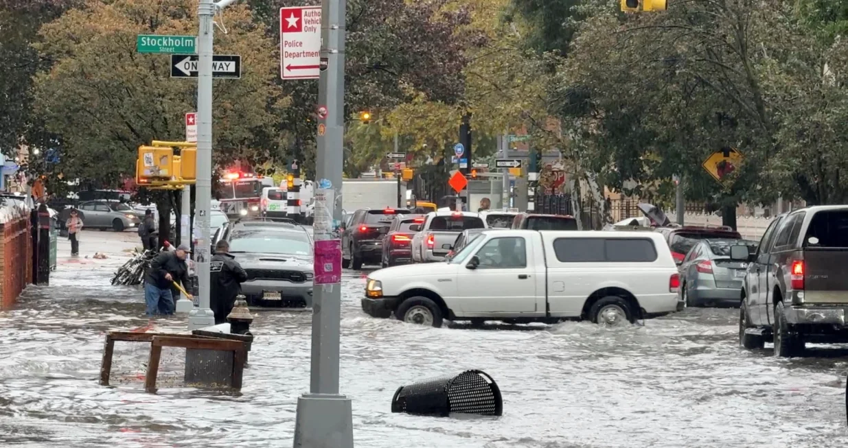 Vehicles move through floodwater in New York City, U.S. October 30, 2025, in this still image obtained from social media video. Mariah Whitmoyer/via REUTERS THIS IMAGE HAS BEEN SUPPLIED BY A THIRD PARTY. MANDATORY CREDIT. NO RESALES. NO ARCHIVES. VERIFICATION: - Location verified by road layout, street signage, buildings' facades and trees that matched file & satellite imagery. Coordinates included in original file metadata - Date verified by original file metadata/Mariah Whitmoyer