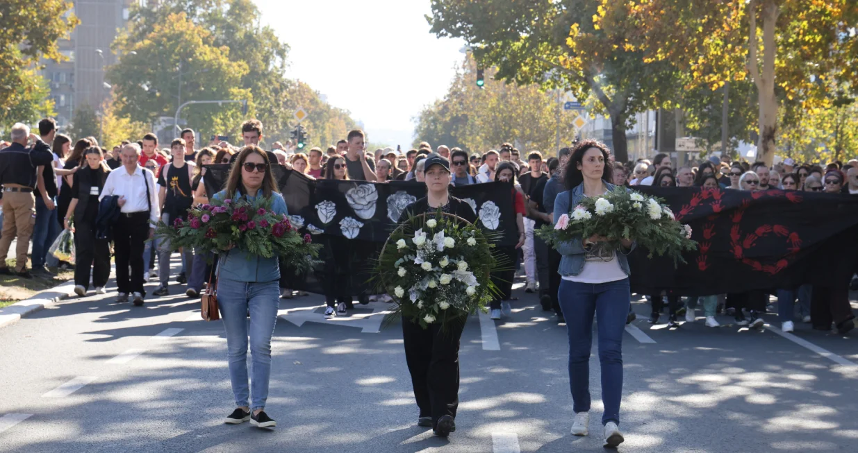 People carry flowers and banners as they gather to mark the first anniversary of the fatal November 2024 Novi Sad railway station canopy collapse, which killed 16 people, triggering nationwide accusations of widespread corruption and negligence, in Novi Sad, Serbia, November 1, 2025. REUTERS/Djordje Kojadinovic/Djordje Kojadinovic