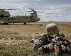 A Polish Armed Forces Soldier scans his sector as a U.S. Army CH-47 Chinook helicopter from the 1-214th General Support Aviation Battalion, 12th Combat Aviation Brigade, loads up personnel in the background, during a joint exercise led by the Polish Armed Forces at the landing zone near the G2A Arena, Poland, April 8, 2022. This exercise and others like it enhances our interoperability with our NATO allies and partners and strengthens the regional relationships that we have developed. 12 CAB is the only enduring aviation brigade present throughout Europe that enables us to deter and defend against threats from any direction. 12 CAB is among other units assigned to V Corps, America's Forward Deployed Corps in Europe that works alongside NATO Allies and regional security partners to provide combat-ready forces, execute joint and multinational training exercises, and retains command and control for all rotational and assigned units in the European Theater.(U.S. Army photo by Staff Sgt. Thomas Mort)/Staff Sgt. Thomas Mort