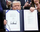 U.S. President Donald Trump poses for a photo after he signs the funding bill to end the U.S. government shutdown, at the White House in Washington, D.C., U.S., November 12, 2025. REUTERS/Kevin Lamarque/Kevin Lamarque