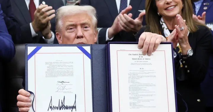 U.S. President Donald Trump poses for a photo after he signs the funding bill to end the U.S. government shutdown, at the White House in Washington, D.C., U.S., November 12, 2025. REUTERS/Kevin Lamarque/Kevin Lamarque