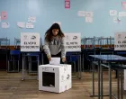 A woman votes in a referendum to decide whether to allow the return of foreign military bases, which Ecuador's President Daniel Noboa says are central to fighting organized crime, and whether they back convening an assembly to rewrite the constitution, at a pooling statioin in Quito, Ecuador November 16, 2025. REUTERS/Karen Toro/Karen Toro