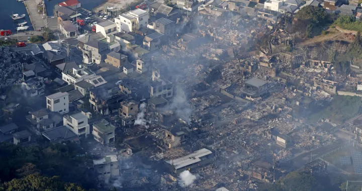 Smoke rises from a site where a massive fire blazed through more than 170 buildings, as seen from a helicopter, in Oita, Oita Prefecture, southwestern Japan, November 19, 2025, in this photo taken by Kyodo. Mandatory credit Kyodo/via REUTERS ATTENTION EDITORS - THIS IMAGE HAS BEEN SUPPLIED BY A THIRD PARTY. MANDATORY CREDIT. JAPAN OUT. NO COMMERCIAL OR EDITORIAL SALES IN JAPAN./Kyodo