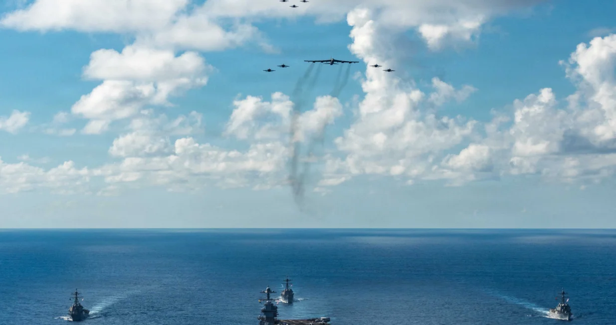 The U.S. Navy's Gerald R. Ford Carrier Strike Group, including the flagship USS Gerald R. Ford, USS Winston S. Churchill, USS Mahan and USS Bainbridge, sail towards the Caribbean Sea under F/A-18E/F Super Hornets and a U.S. Air Force B-52 Stratofortress, in the Atlantic Ocean November 13, 2025. U.S. Navy/Petty Officer 3rd Class Gladjimi Balisage/Handout via REUTERS. THIS IMAGE HAS BEEN SUPPLIED BY A THIRD PARTY/Us Navy