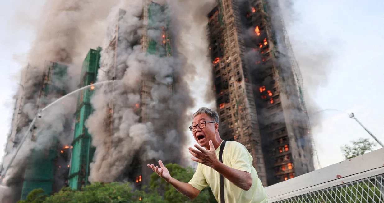 Wong 71, reacts after claiming his wife is trapped inside Wang Fuk Court during a major fire, in Tai Po, Hong Kong, China, November 26, 2025. REUTERS/Tyrone Siu TPX IMAGES OF THE DAY/Tyrone Siu
