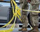 National Guard members stand together behind yellow tape, after two National Guard members were shot near the White House in Washington, D.C., U.S., November 26, 2025. REUTERS/Nathan Howard/Nathan Howard