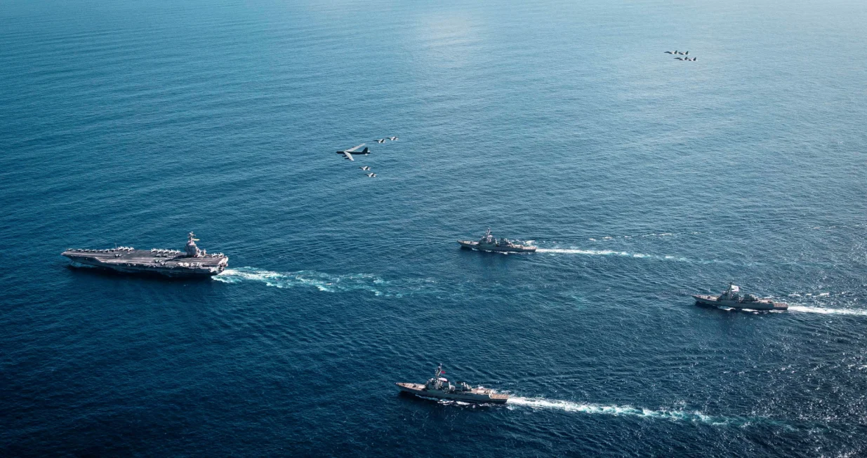 The U.S. Navy's Gerald R. Ford Carrier Strike Group, including the flagship USS Gerald R. Ford, USS Winston S. Churchill, USS Mahan and USS Bainbridge, sail towards the Caribbean Sea under F/A-18E/F Super Hornets and a U.S. Air Force B-52 Stratofortress, in the Atlantic Ocean November 13, 2025. U.S. Navy/Petty Officer 3rd Class Tajh Payne/Handout via REUTERS. THIS IMAGE HAS BEEN SUPPLIED BY A THIRD PARTY/Us Navy