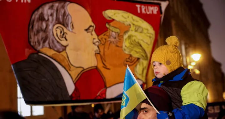 Protesters display a banner with caricatures of Russian President Vladimir Putin and U.S. President Donald Trump as people demonstrate against a plan drafted by the U.S. President Donald Trump's administration to end the war in Ukraine during a protest rally called "No to Munich 2025. Do not sell out Ukraine", in front of the U.S. Embassy in Prague, Czech Republic, November 25, 2025. REUTERS/Eva Korinkova/Eva Korinkova