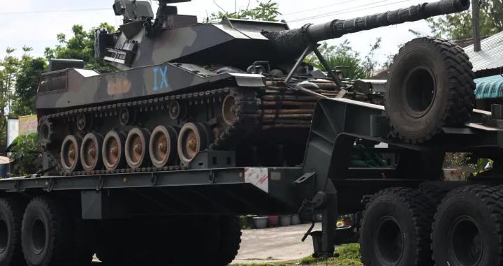 A military truck carries a tank on a road amid deadly clashes between Thailand and Cambodia along a disputed border area, in Surin province, Thailand, December 11, 2025. REUTERS/Athit Perawongmetha/Athit Perawongmetha