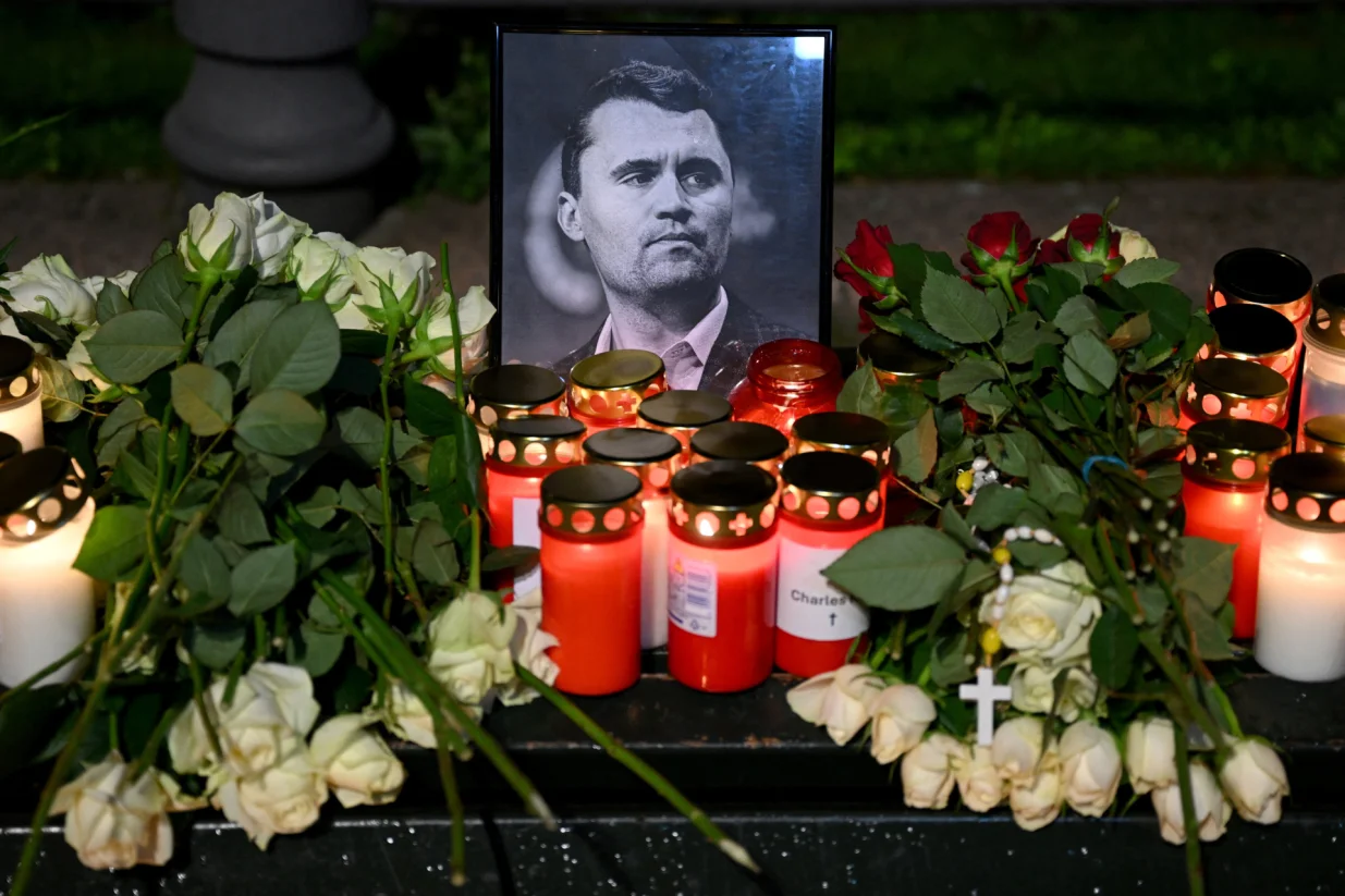 Roses and candles are placed next to a picture of Charlie Kirk during a vigil under the line "In Memory of Charlie Kirk, for freedom, patriotism and justice" in front of the Embassy of the United States after U.S. right-wing activist, commentator, Charlie Kirk, an ally of U.S. President Donald Trump, was shot dead during an event at Utah Valley University, Orem, U.S., in Berlin, Germany September 11, 2025. REUTERS/Annegret Hilse/Annegret Hilse