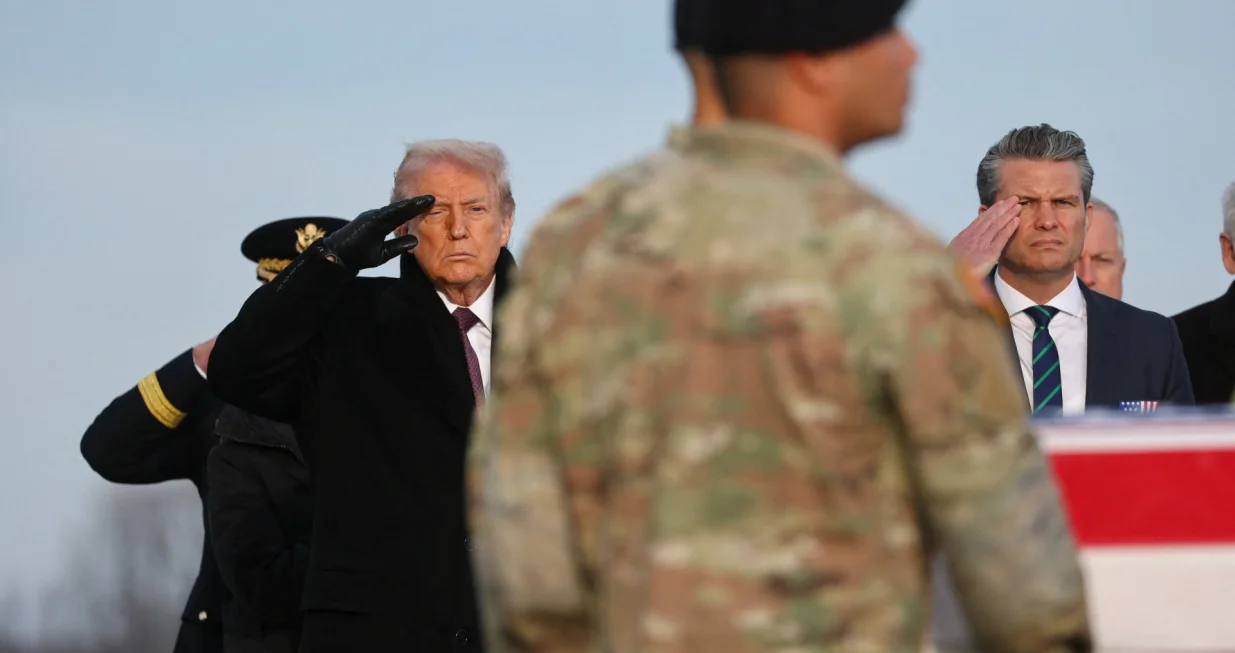 U.S. President Donald Trump and Secretary of Defense Pete Hegseth salute, as members of the military carry a transfer case, during a dignified transfer of the remains of two Iowa National Guard members killed in Syria, Sgt. Edgar Torres Tovar and Sgt. William Howard, and Ayad Mansoor Sakat, of Macomb, Michigan, who was working as an interpreter in Syria, at Dover Air Force Base in Dover, Delaware, U.S., December. 17, 2025. REUTERS/Jonathan Ernst/Jonathan Ernst