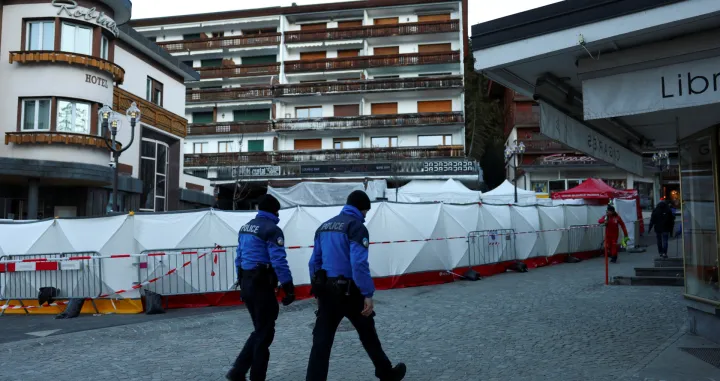 Swiss police officers walk outside the "Le Constellation" bar, after a fire and explosion during a New Year's Eve party where several people died, and others were injured, according to Swiss police, in the upscale ski resort of Crans-Montana in southwestern Switzerland, January 3, 2026. REUTERS/Denis Balibouse/Denis Balibouse