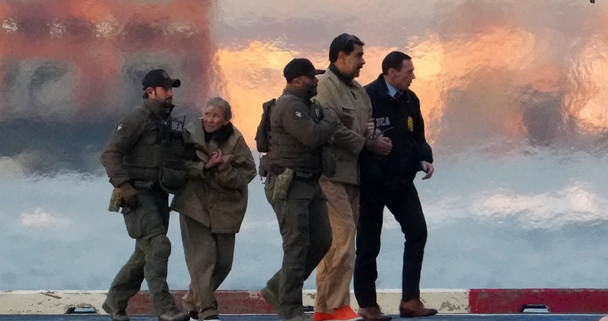 Law enforcement officials move captured Venezuelan President Nicolas Maduro and his wife Cilia Flores out of the helicopter, as Maduro heads towards the Daniel Patrick Manhattan United States Courthouse for an initial appearance to face U.S. federal charges including narco-terrorism, conspiracy, drug trafficking, money laundering and others in New York City, U.S., January 5, 2026. REUTERS/Adam Gray  TPX IMAGES OF THE DAY/Adam Gray