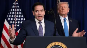 U.S. Secretary of State Marco Rubio speaks as U.S. President Donald Trump stands behind him during a press conference following a U.S. strike on Venezuela where President Nicolas Maduro and his wife, Cilia Flores, were captured, from Trump's Mar-a-Lago club in Palm Beach, Florida, U.S., January 3, 2026. REUTERS/Jonathan Ernst/Jonathan Ernst