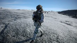 FILE PHOTO: A member of the French armed forces walks on ice during a military drill as Danish, Swedish and Norwegian home guard units together with Danish, German and French troops take part in joint military drills in Kangerlussuaq, Greenland, September 17, 2025. REUTERS/Guglielmo Mangiapane/File Photo/Guglielmo Mangiapane