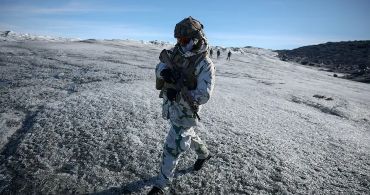 FILE PHOTO: A member of the French armed forces walks on ice during a military drill as Danish, Swedish and Norwegian home guard units together with Danish, German and French troops take part in joint military drills in Kangerlussuaq, Greenland, September 17, 2025. REUTERS/Guglielmo Mangiapane/File Photo/Guglielmo Mangiapane