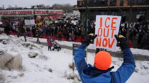 A demonstrator holds a placard during an "ICE Out of Minnesota" rally and march organized by MIRAC (Minnesota Immigrant Rights Action Committee), in Minneapolis, Minnesota, U.S., January 10, 2026. REUTERS/Tim Evans  TPX IMAGES OF THE DAY/Tim Evans
