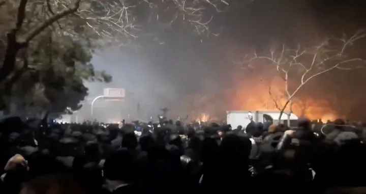 Smoke rises as protesters gather amid evolving anti-government unrest at Vakilabad highway in Mashhad, Razavi Khorasan province, Iran, released on January 10, 2026, in this screen grab obtained from a social media video. SOCIAL MEDIA/via REUTERS THIS IMAGE HAS BEEN SUPPLIED BY A THIRD PARTY. MANDATORY CREDIT. NO RESALES. NO ARCHIVES. Verification lines: Reuters was able to confirm the location of the videos by the bridge, road signboard, and trees which matched satellite and file imagery of the area. The date could not be independently verified. But several corroborating videos, also uploaded on January 10, showed similar scenes at that location./Social Media
