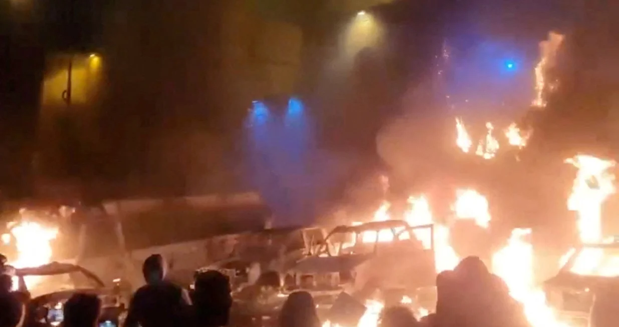 Protesters gather as vehicles burn, amid evolving anti-government unrest, in Tehran, Iran, in this screen grab obtained from a social media video released on January 9, 2026. Social Media/via REUTERS THIS IMAGE HAS BEEN SUPPLIED BY A THIRD PARTY. NO RESALES. NO ARCHIVES. REFILE - QUALITY REPEAT VERIFICATION: - Buildings, business signage and traffic light matched file and satellite imagery - Date not verified - Witnesses told Reuters protesters gathered in the streets on Thursday (January 8)/Social Media