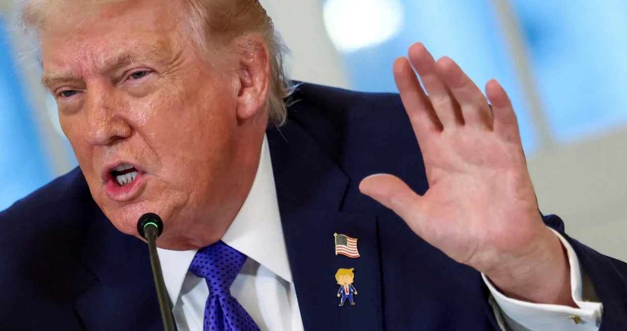 FILE PHOTO: U.S. President Donald Trump wearing a "happy Trump" pin speaks during a meeting with oil industry executives at the White House in Washington, D.C., U.S., January 9, 2026. REUTERS/Kevin Lamarque/File Photo/Kevin Lamarque