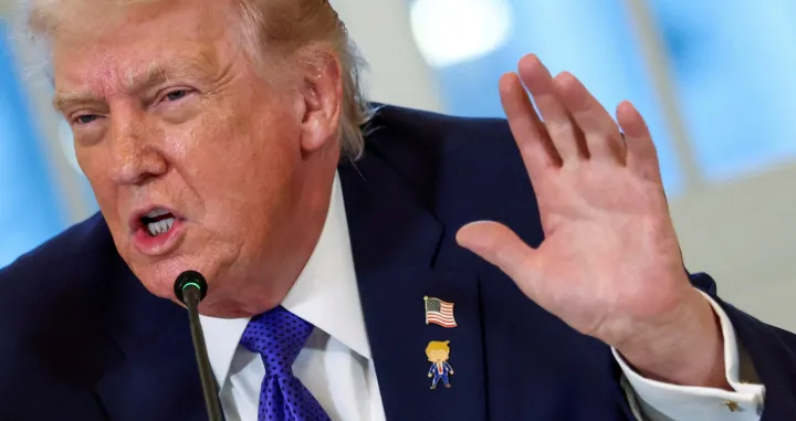 FILE PHOTO: U.S. President Donald Trump wearing a "happy Trump" pin speaks during a meeting with oil industry executives at the White House in Washington, D.C., U.S., January 9, 2026. REUTERS/Kevin Lamarque/File Photo/Kevin Lamarque