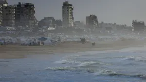 Palestinians walk on a beach during a weather disturbance in Gaza City, January 9, 2026. REUTERS/Dawoud Abu Alkas/Dawoud Abu Alkas