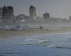 Palestinians walk on a beach during a weather disturbance in Gaza City, January 9, 2026. REUTERS/Dawoud Abu Alkas/Dawoud Abu Alkas