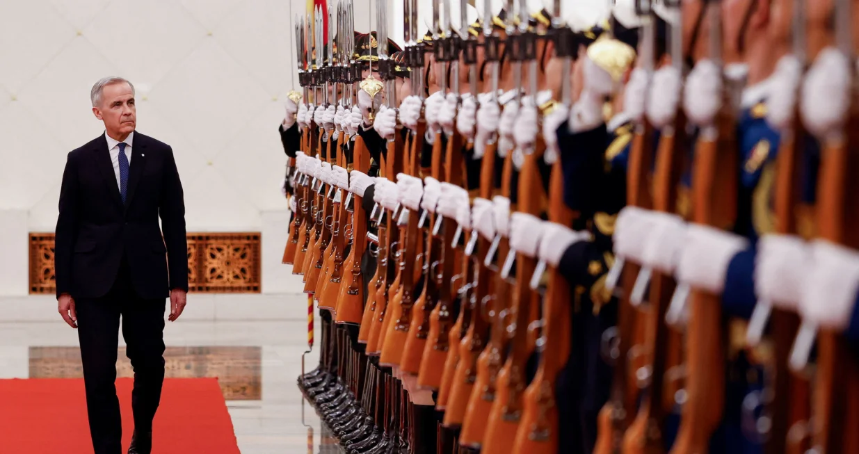 Canada's Prime Minister Mark Carney reviews the honour guard at an official welcoming ceremony, during the first visit by a Canadian prime minister to China since 2017, at the Great Hall of the People in Beijing, China January 15, 2026. REUTERS/Carlos Osorio/Carlos Osorio