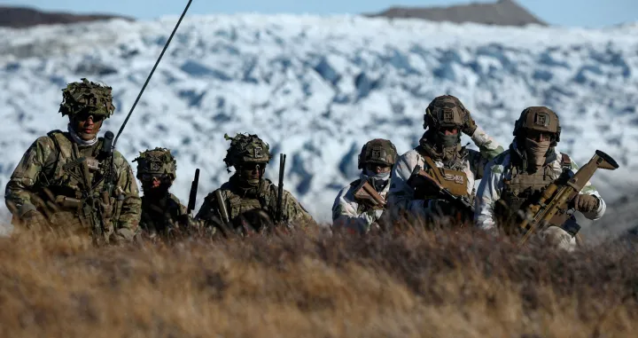 FILE PHOTO: Danish troops practice looking for potential threats during a military drill as Danish, Swedish and Norwegian home guard units together with Danish, German and French troops take part in joint military drills in Kangerlussuaq, Greenland, September 17, 2025. REUTERS/Guglielmo Mangiapane/File Photo/Guglielmo Mangiapane