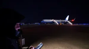 Members of the media wait for U.S. President Donald Trump to deboard Air Force One after returning to Joint Base Andrews following an electrical problem identified mid-flight en route to Davos, Switzerland, at Joint Base Andrews, Maryland, U.S., January 20, 2026. REUTERS/Jonathan Ernst/Jonathan Ernst