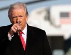 U.S. President Donald Trump gestures, before boarding Air Force One en route to Detroit, Michigan, at Joint Base Andrews, Maryland, U.S., January 13, 2026. REUTERS/Evelyn Hockstein/Evelyn Hockstein