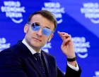 FILE PHOTO: France's President Emmanuel Macron wears sunglasses as he attends the 56th annual World Economic Forum (WEF) meeting in Davos, Switzerland, January 20, 2026. REUTERS/Denis Balibouse/File Photo/Denis Balibouse