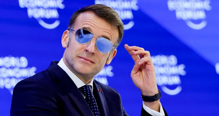 FILE PHOTO: France's President Emmanuel Macron wears sunglasses as he attends the 56th annual World Economic Forum (WEF) meeting in Davos, Switzerland, January 20, 2026. REUTERS/Denis Balibouse/File Photo/Denis Balibouse