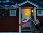 A person displays a Greenlandic flag, as people protest in front of the U.S. consulate in Nuuk, Greenland, January 22, 2026. REUTERS/Marko Djurica  TPX IMAGES OF THE DAY/Marko Djurica