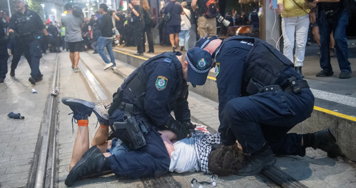 Police officers detain a protester as demonstrators gather at Town Hall Square to protest against Israeli President Isaac Herzog's state visit to Australia following a deadly mass shooting during a Jewish Hanukkah celebration at Bondi Beach on December 14, in Sydney, Australia, February 9, 2026. REUTERS/Jeremy Piper вЂЋ/Jeremy Piper