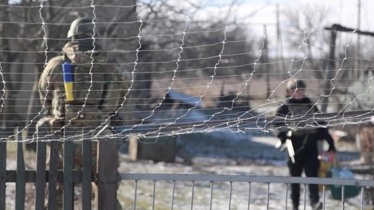 Ukrainian national police officers stand near an anti-drone net, during an evacuation of residents from the Tavriiske and Yurkivka villages in Ukraine's Zaporizhzhia region, amid Russia's attack on Ukraine, in this screengrab from a video, February 3, 2026. Reuters TV via REUTERS THIS IMAGE HAS BEEN SUPPLIED BY A THIRD PARTY/Reuters Tv