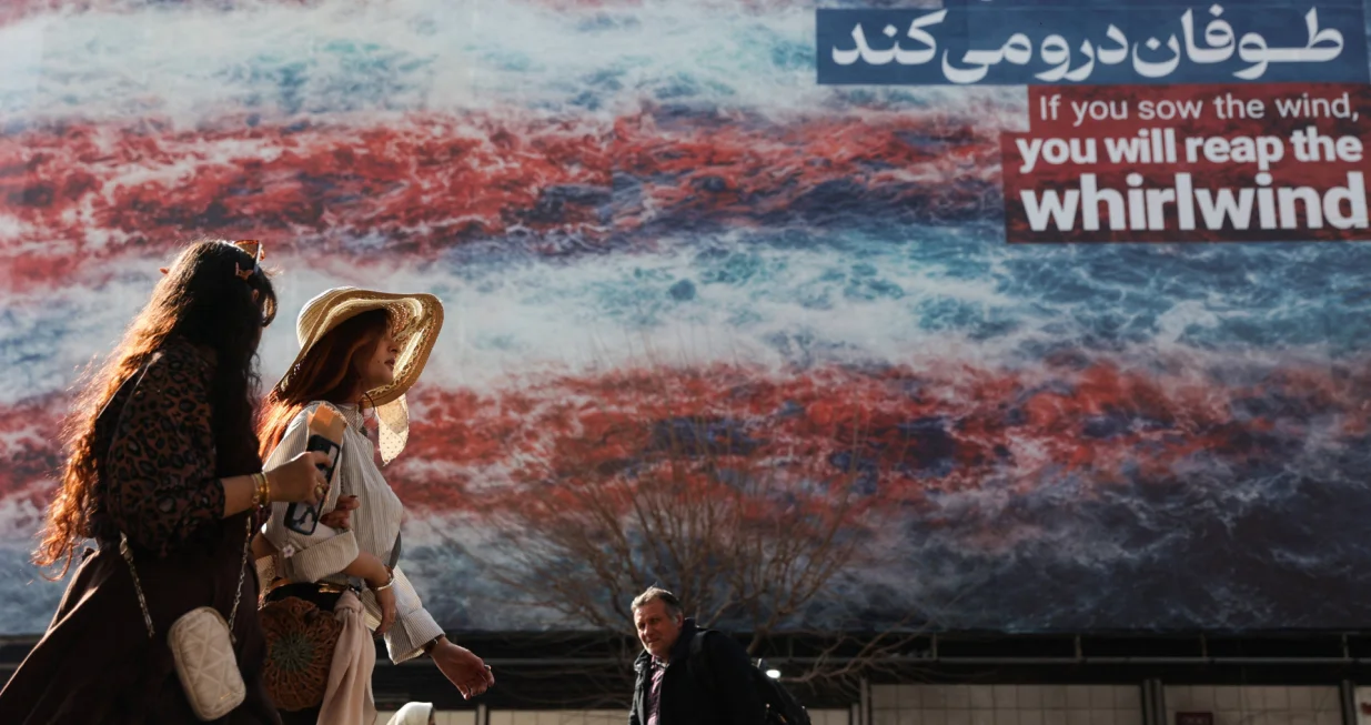 Iranian women walk past an anti-U.S. billboard in Tehran, Iran, February 19, 2026. Majid Asgaripour/WANA (West Asia News Agency) via REUTERS ATTENTION EDITORS - THIS PICTURE WAS PROVIDED BY A THIRD PARTY/Majid Asgaripour