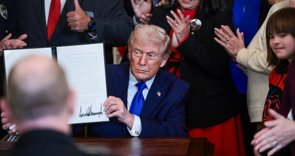 U.S. President Donald Trump holds a proclamation establishing "Angel Family Day", during an event to honor "Angel Families" who have lost family members to crimes committed by people in the country illegally, at the White House in Washington, D.C., U.S., February 23, 2026. REUTERS/Evelyn Hockstein/Evelyn Hockstein
