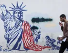A man walks past a mural depicting a damaged Statue of Liberty, on a street in Tehran, Iran, February 26, 2026. Majid Asgaripour/WANA (West Asia News Agency) via REUTERS ATTENTION EDITORS - THIS PICTURE WAS PROVIDED BY A THIRD PARTY  TPX IMAGES OF THE DAY/Majid Asgaripour